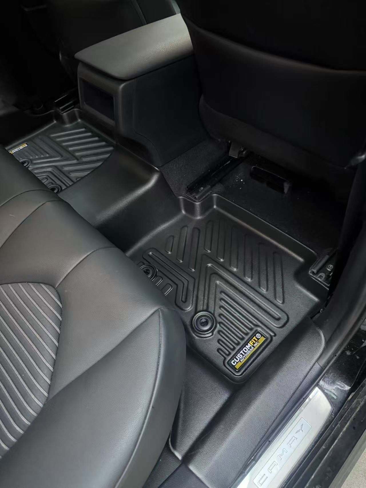2018-2024 Toyota Camry Hybrid Second Row car interior with black All-Weather Floor Mats on a gray floor.