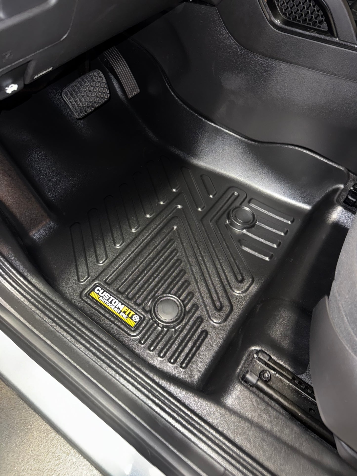 Black Chevrolet Trailblazer FWD car floor mat with a brand logo on a vehicle interior.