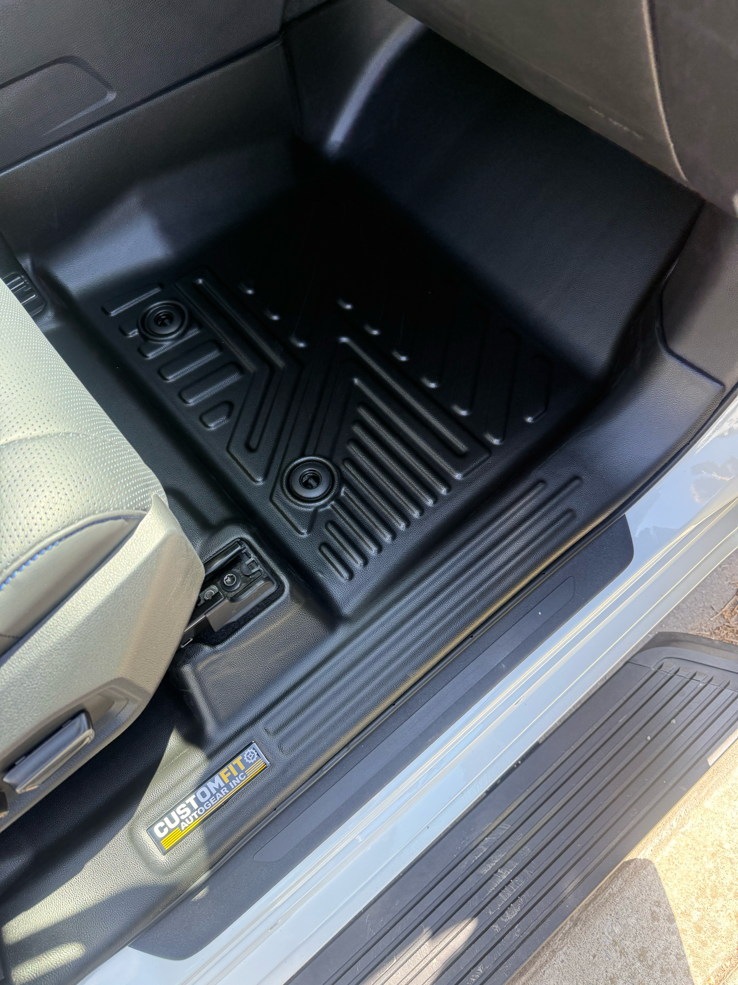 Toyota Tundra Crew Max passenger Seat car interior with black floor mats.