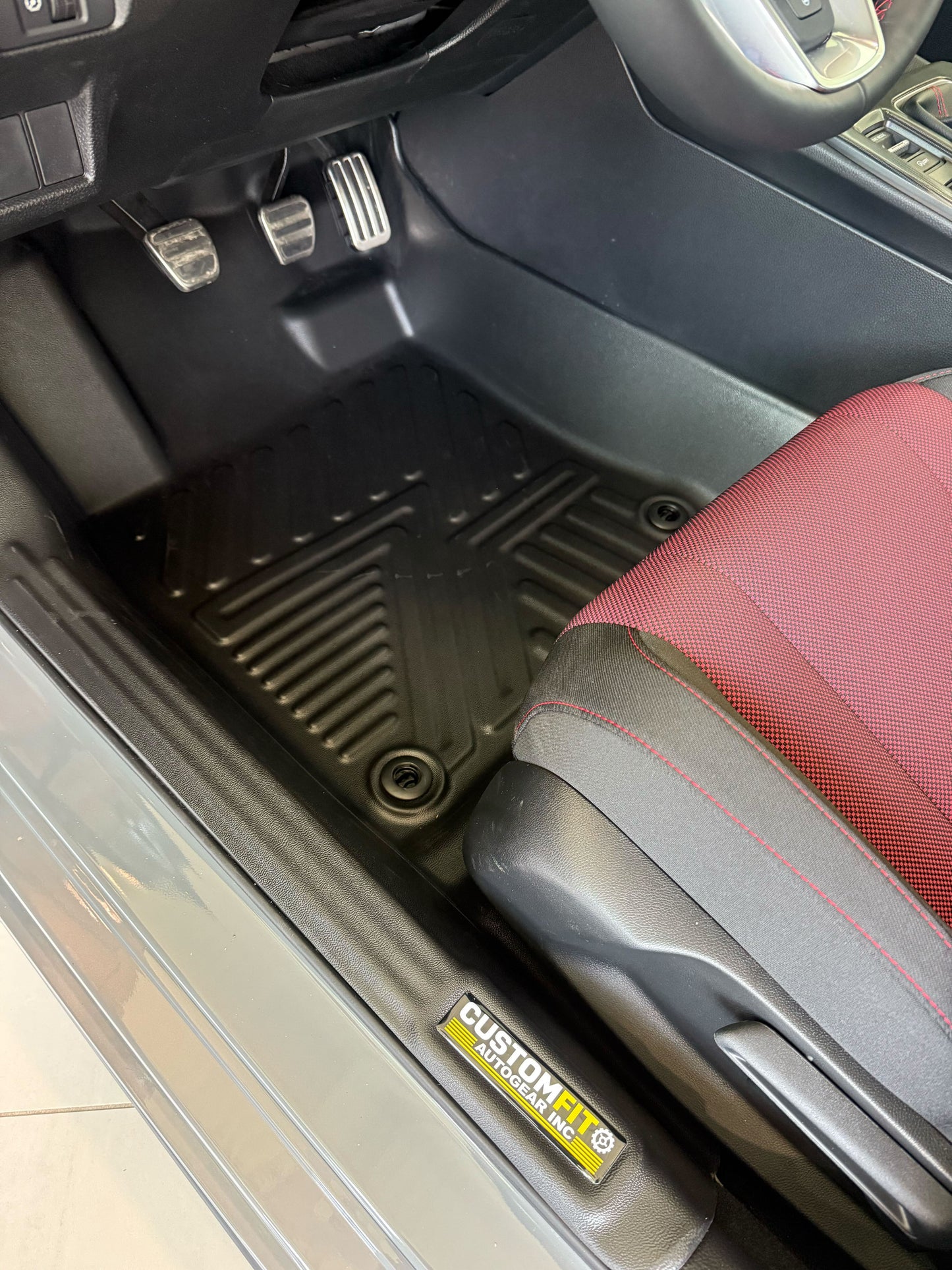 Honda civic hybrid car interior with a custom fit floor mat and visible brand logo.