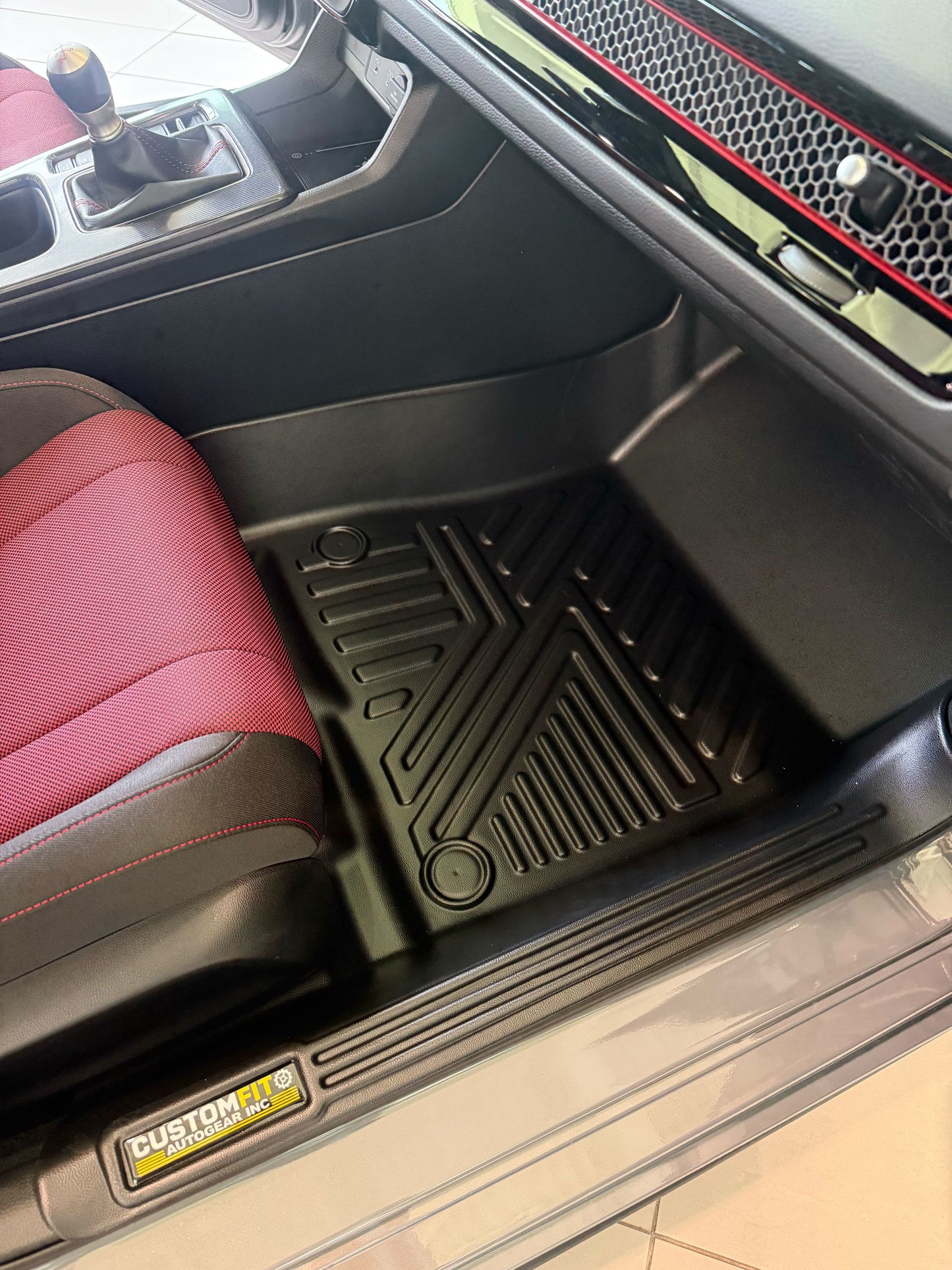 Honda civic hybrid car interior with a red seat and black floor mat, featuring a 'Custom Fit' logo.