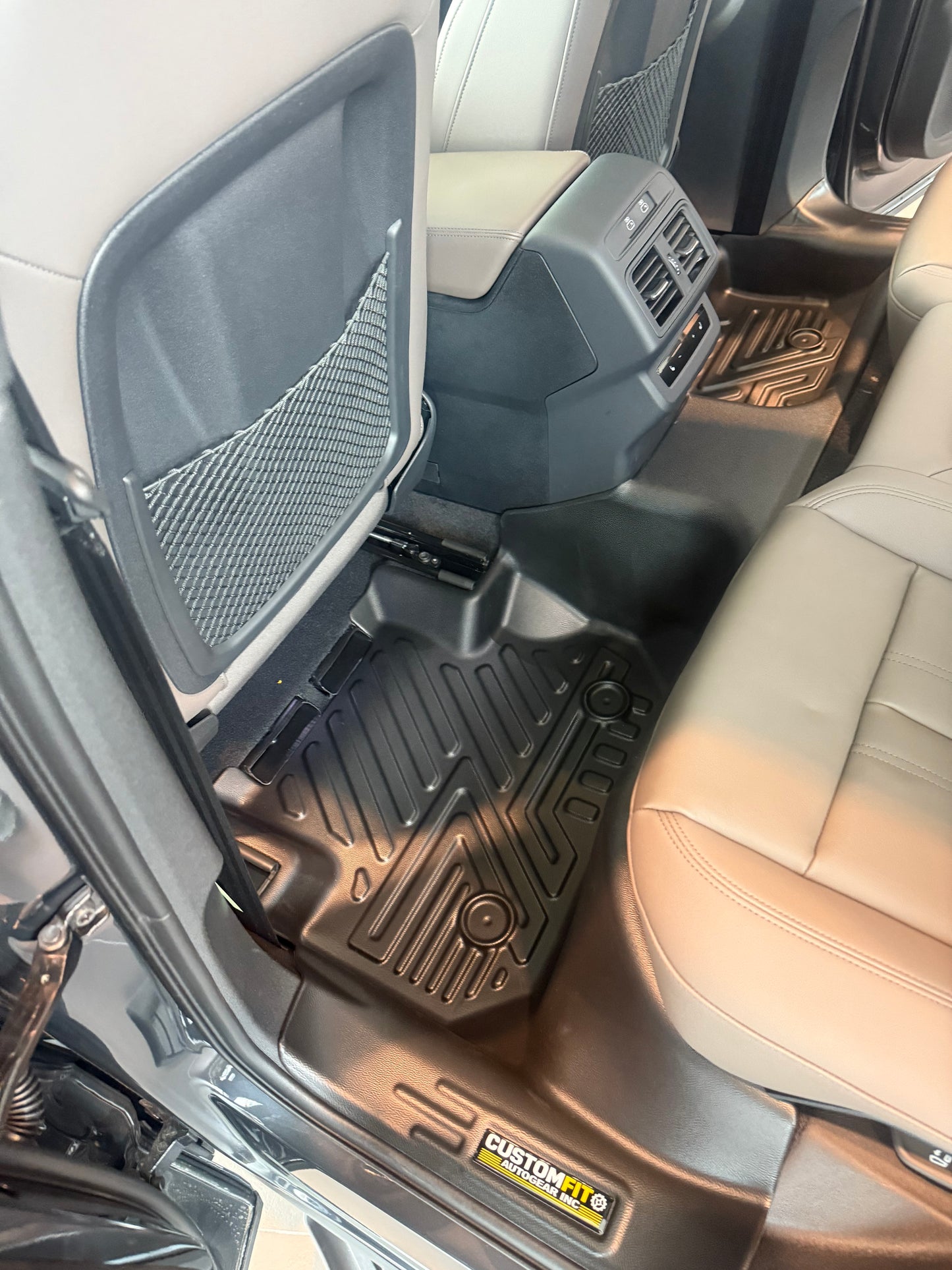Audi Q5 Car interior with black floor mats and a visible brand logo.