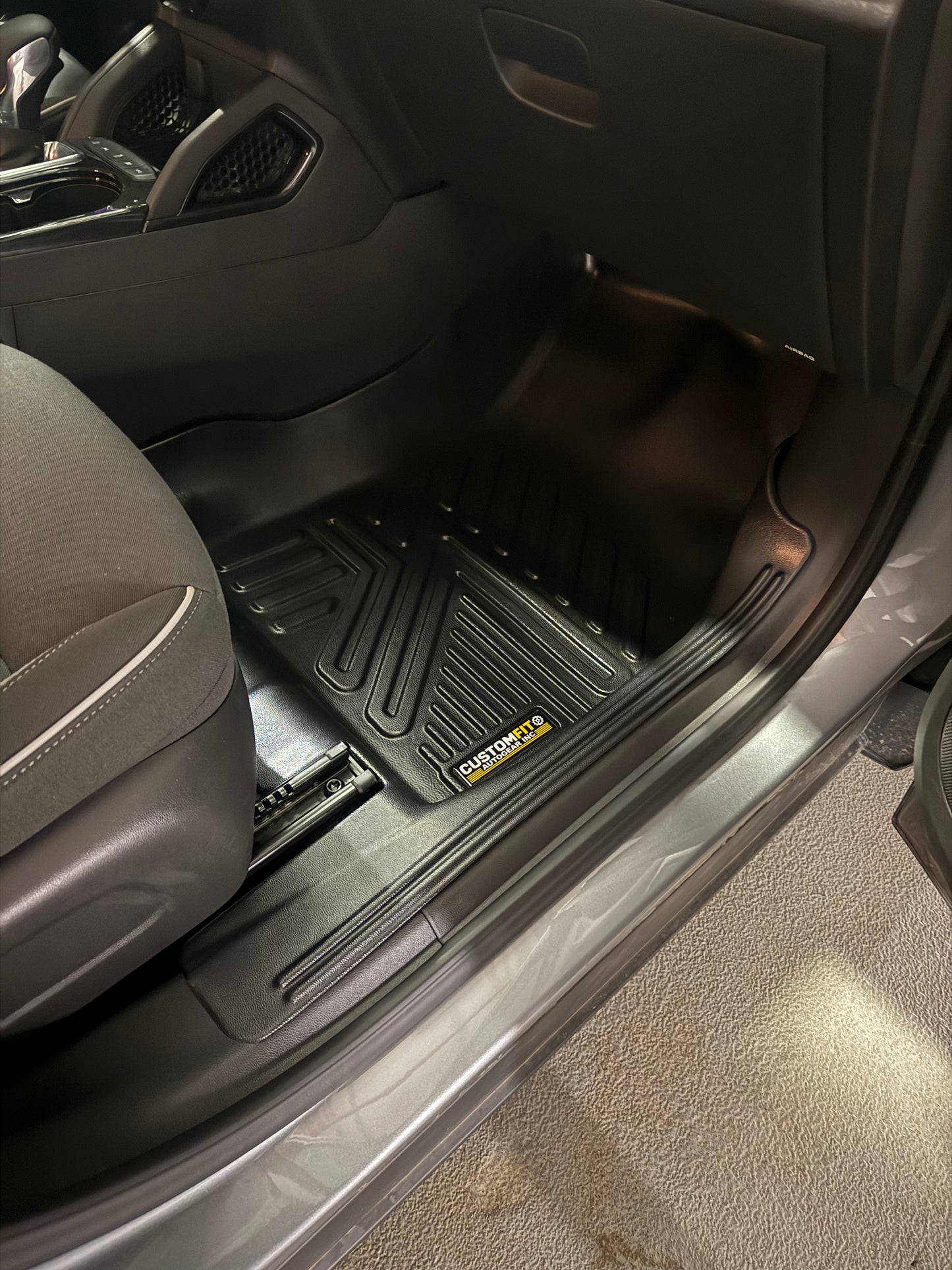 Black Chevrolet Trailblazer FWD Car interior with a black floor mat on a carpeted floor